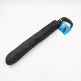 Black folded umbrella with a blue tag on a white background