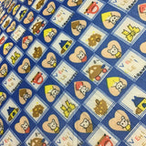 Patterned fabric with cartoon characters and shapes on a blue background