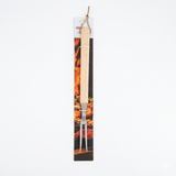 Wooden handled grill fork with a decorative background of food images on a white background